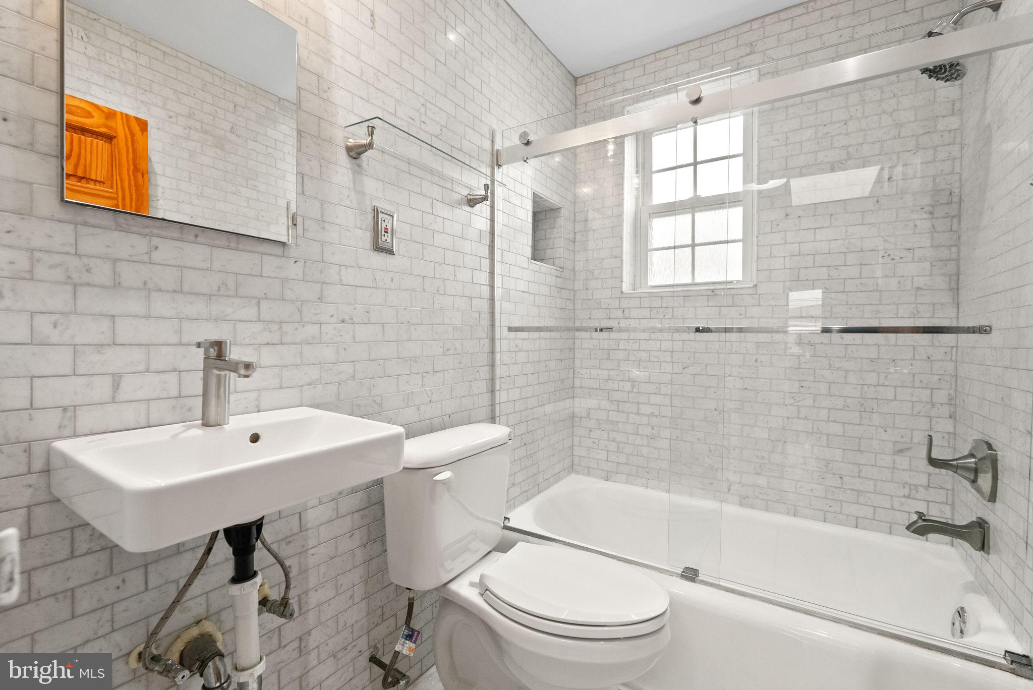 518 Riggs Road Northeast Washington, DC 20011 - Photo 12 of 18 a bathroom with a sink a toilet and shower