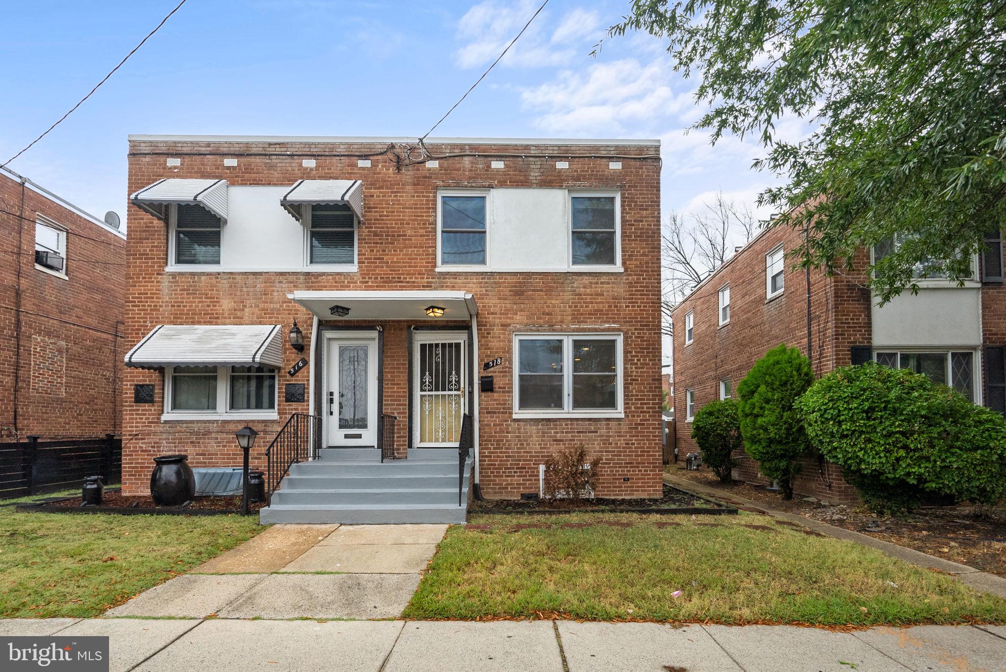 518 Riggs Road Northeast Washington, DC 20011 - Photo 16 of 18 a view of a brick house with many windows plants and large tree