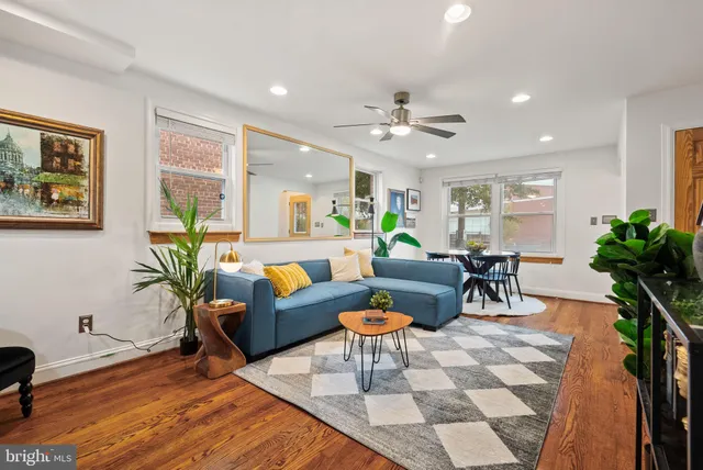 a living room with furniture potted plant and a window