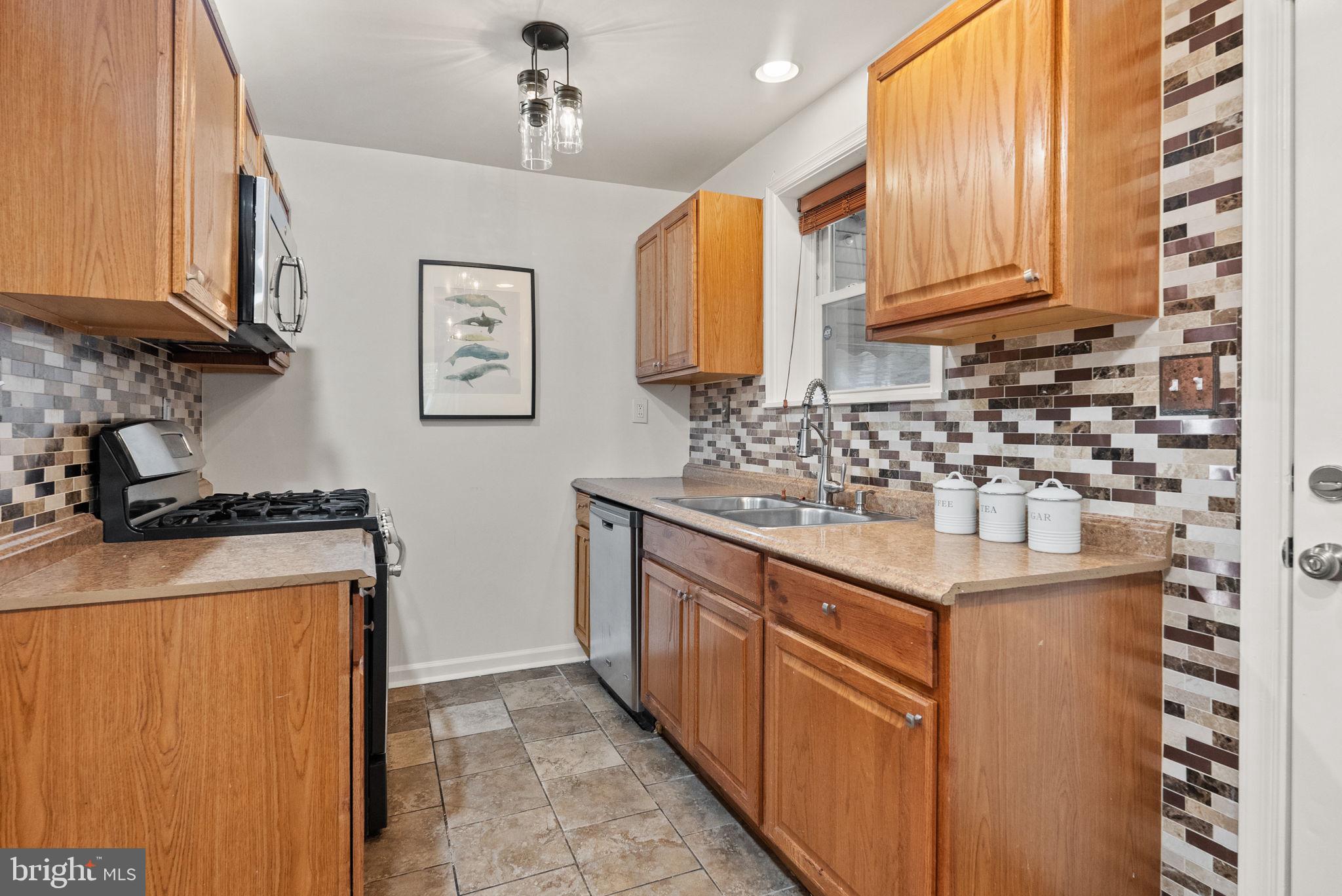 518 Riggs Road Northeast Washington, DC 20011 - Photo 4 of 18 a kitchen with stainless steel appliances granite countertop a sink stove and refrigerator
