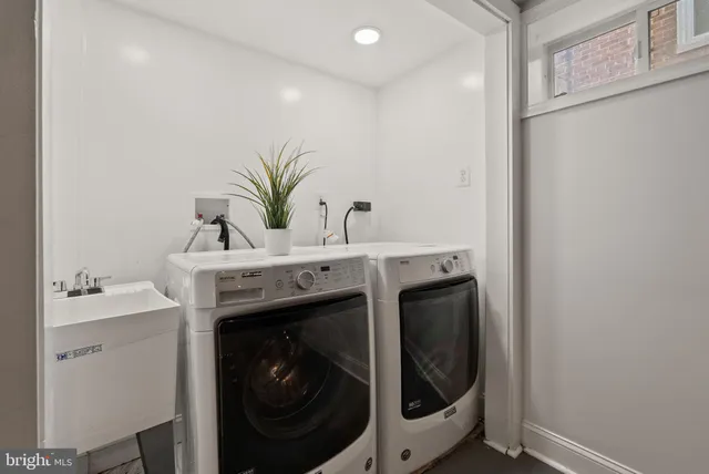 a utility room with a sink dryer and washer