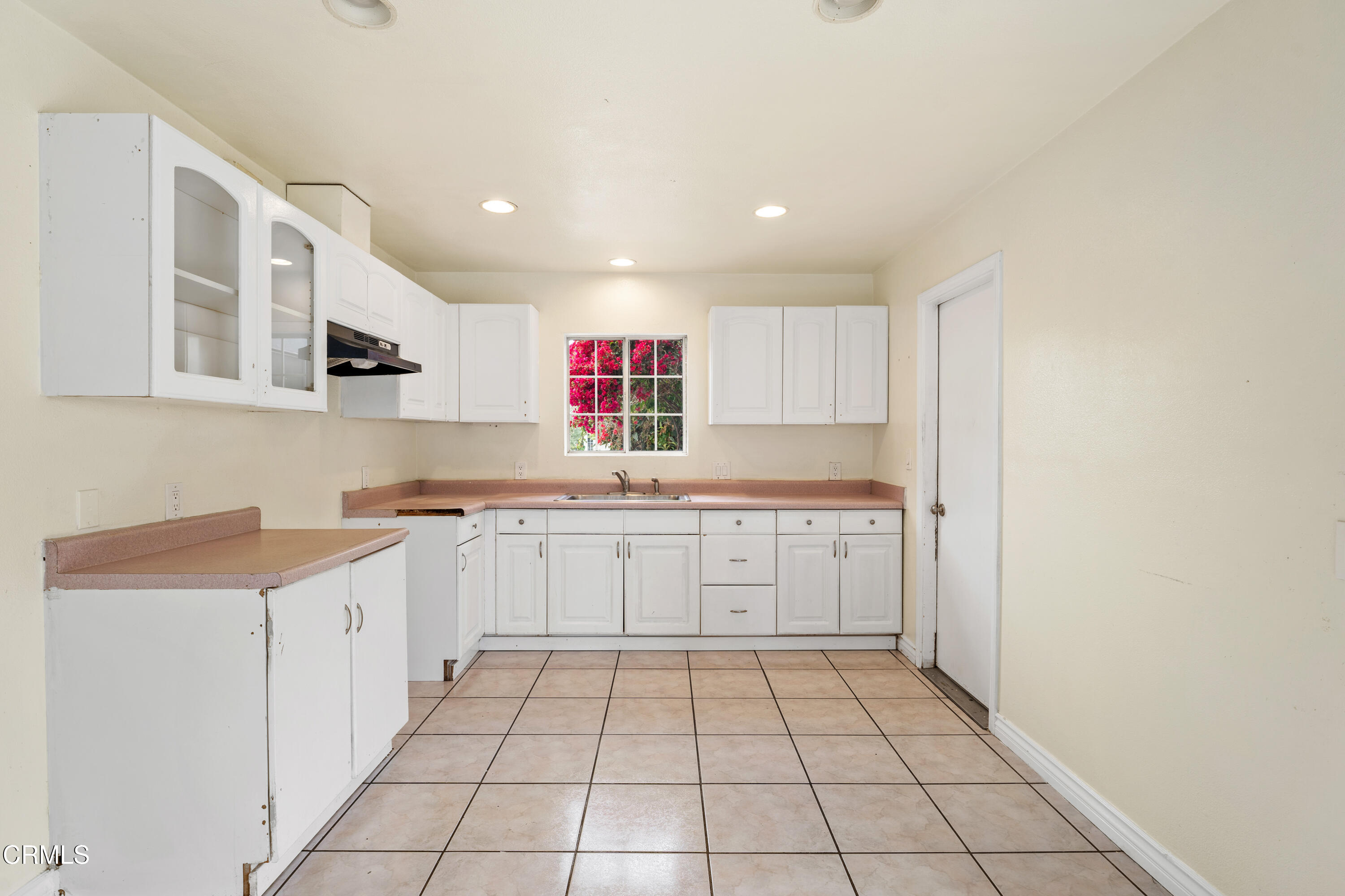 918 Ann Arbor Avenue Ventura, CA 93004 - Photo 13 of 25 a kitchen with a sink window and cabinets