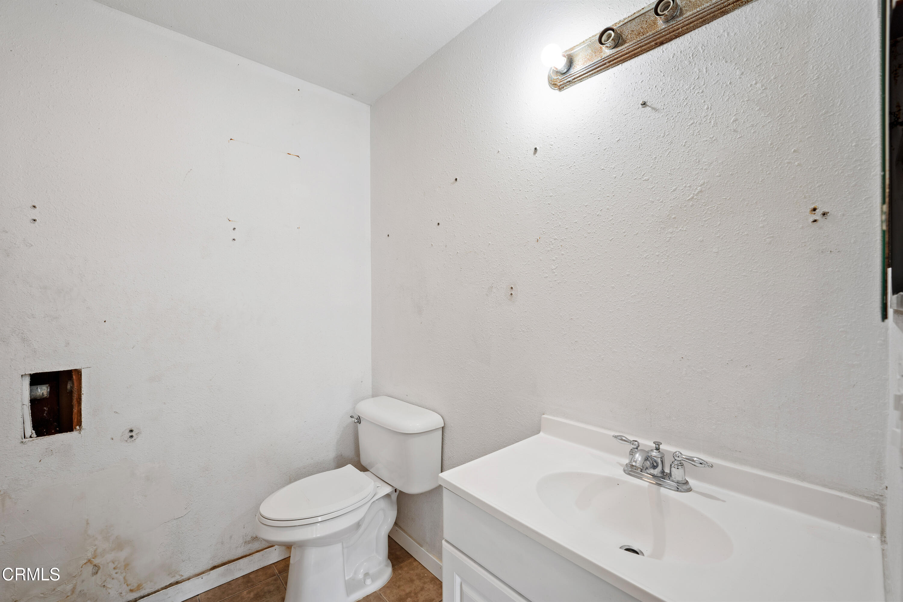 918 Ann Arbor Avenue Ventura, CA 93004 - Photo 17 of 25 a white toilet sitting next to a bathroom sink