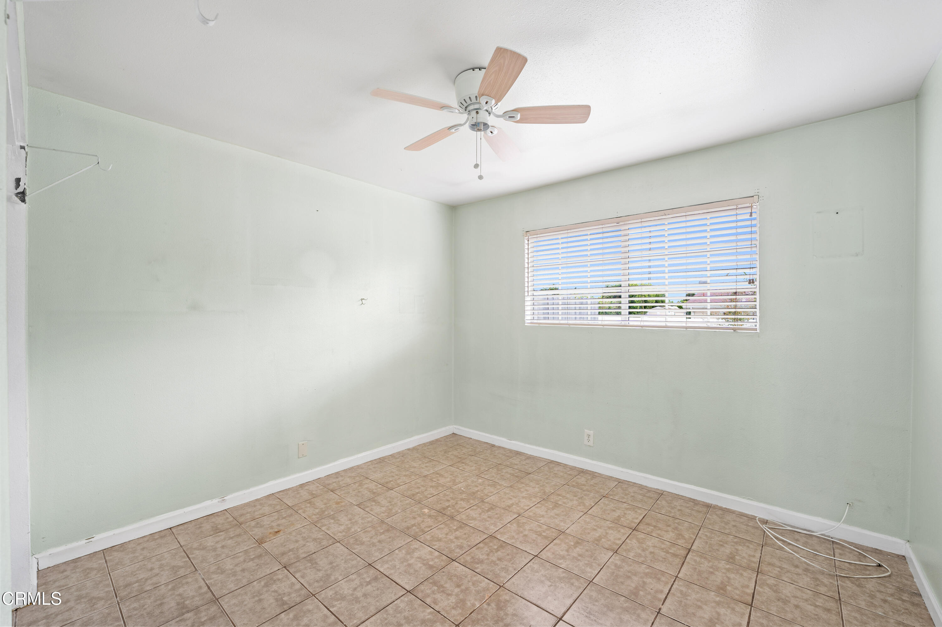 918 Ann Arbor Avenue Ventura, CA 93004 - Photo 21 of 25 an empty room with a ceiling fan and window