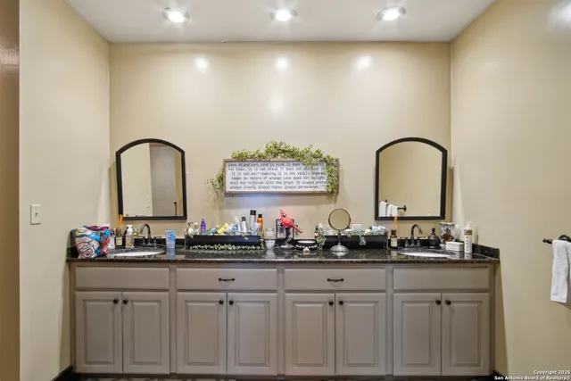 a close view of two sink a counter top space and a dining table with wooden floor