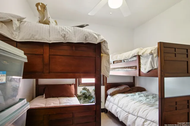 a bedroom with a bed and dresser with mirror