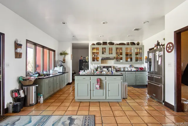 a kitchen with stainless steel appliances granite countertop a refrigerator and a stove