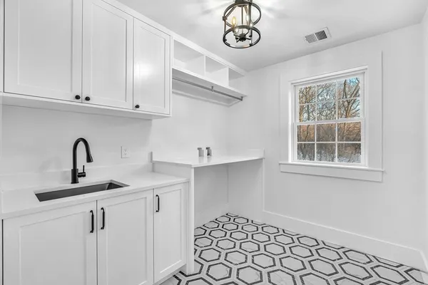 a kitchen with a sink cabinets and window