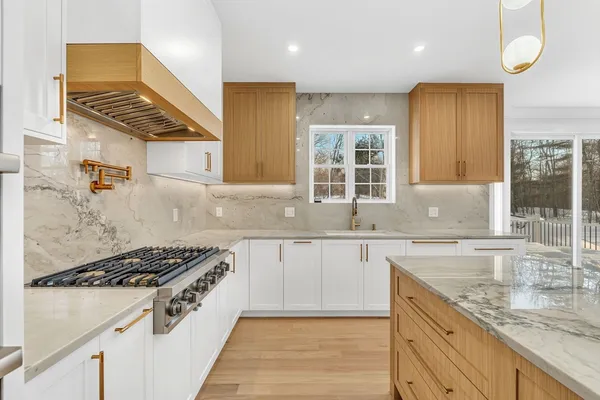 a kitchen with granite countertop a sink stove and cabinets