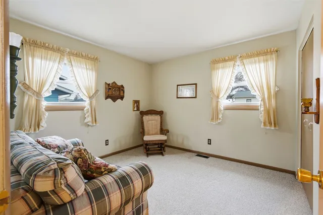 a bedroom with a bed and windows