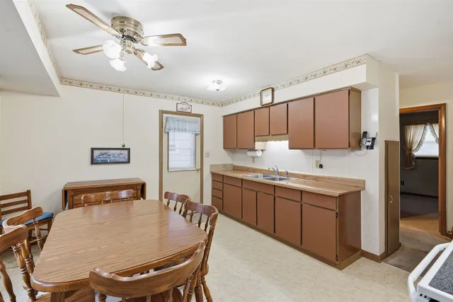 a large kitchen with a table and chairs