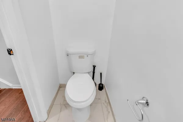 a white toilet sitting next to a shower