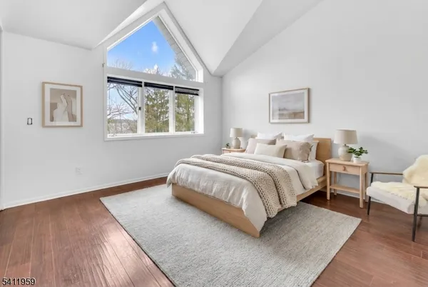 a bedroom with bed and a night stand