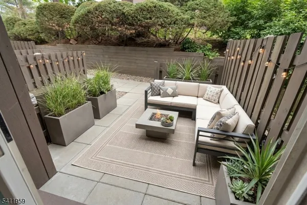 a view of patio with furniture and a garden
