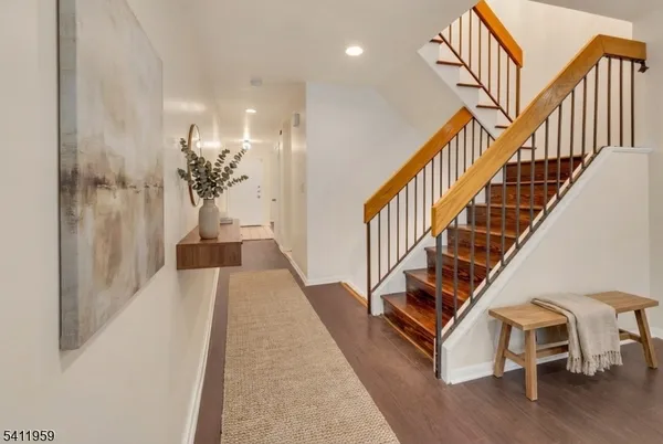 a view of entryway and hall with wooden floor