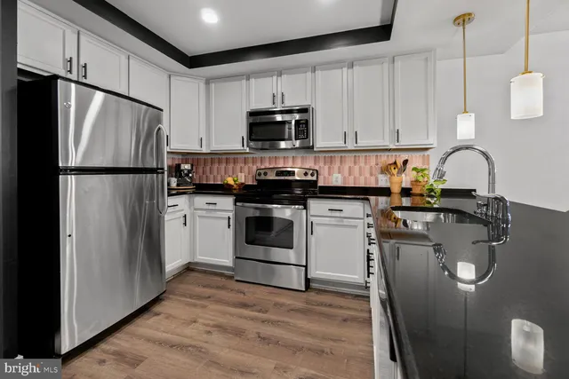 a kitchen with a refrigerator sink and stove