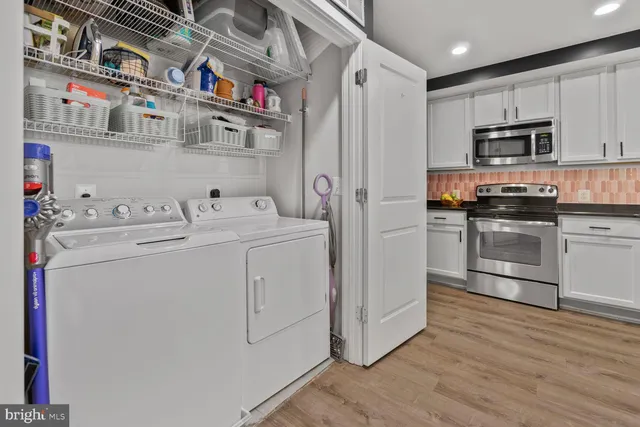 a kitchen with stainless steel appliances granite countertop a sink and wooden cabinets