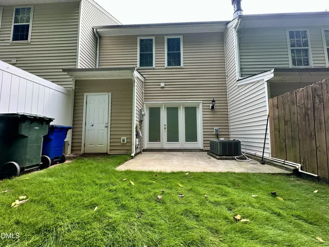 a backyard of a house with barbeque oven
