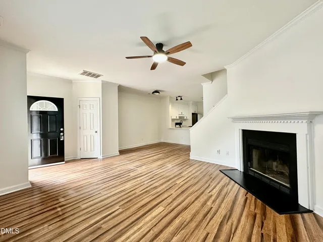 a view of a livingroom with a fireplace and ceiling fan