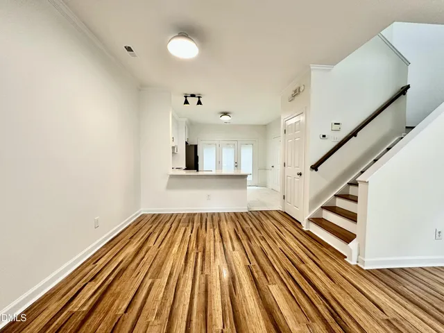 a view of a room with wooden floor and staircase