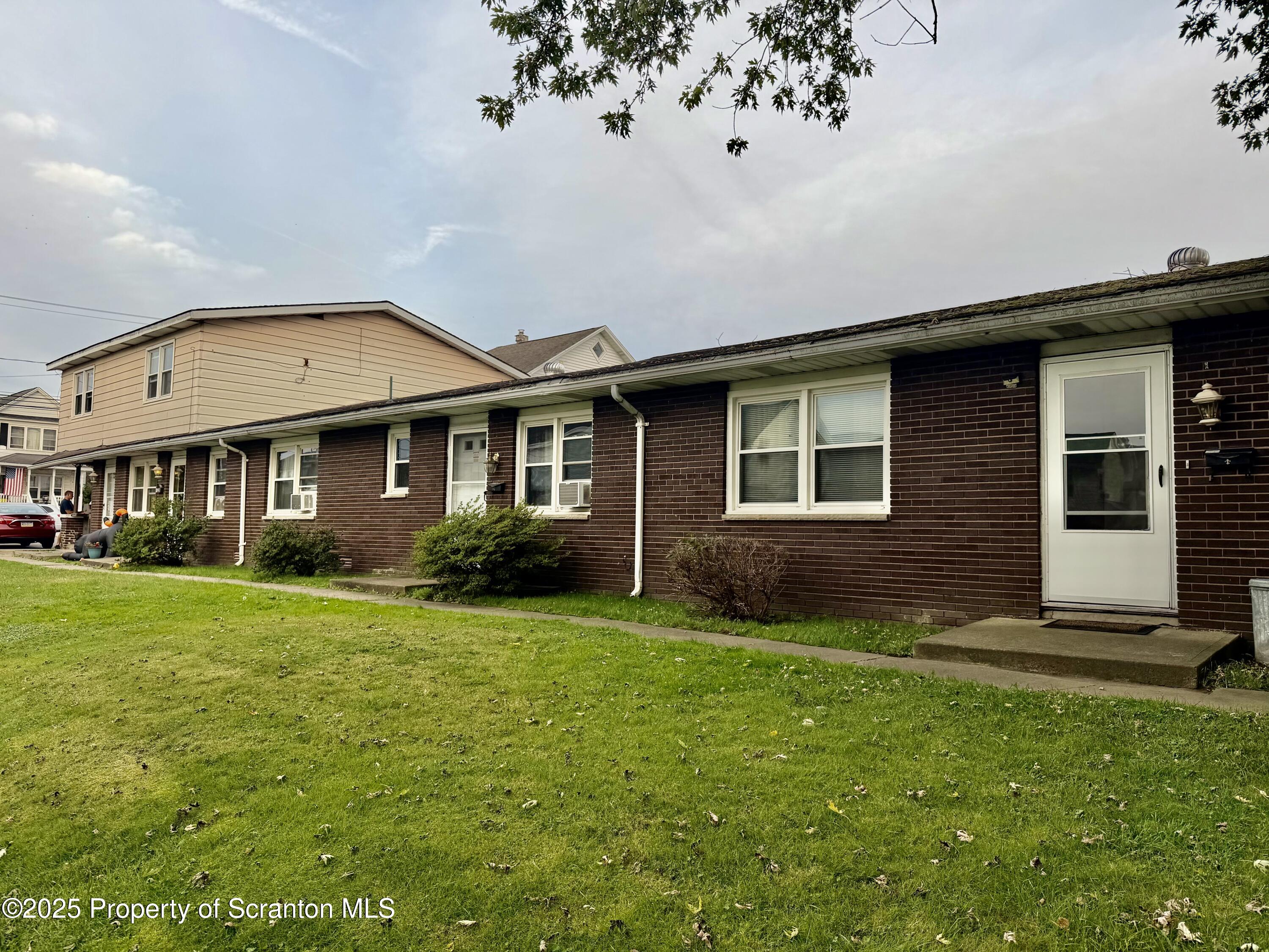 612 Oak Street Old Forge, PA 18518 - Photo 1 of 17 a front view of a house with a garden
