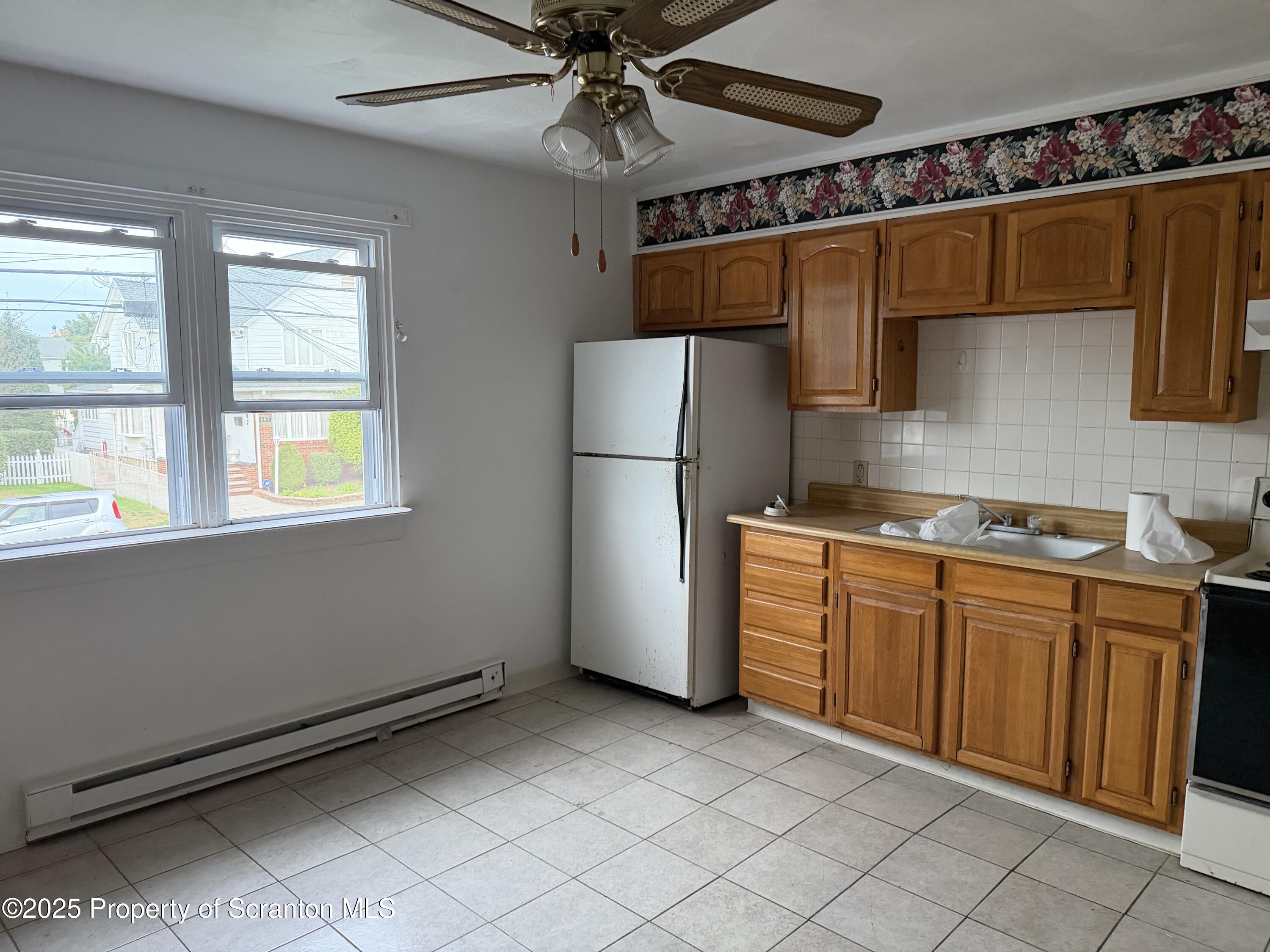 612 Oak Street Old Forge, PA 18518 - Photo 11 of 17 a kitchen with granite countertop a refrigerator a sink and dishwasher