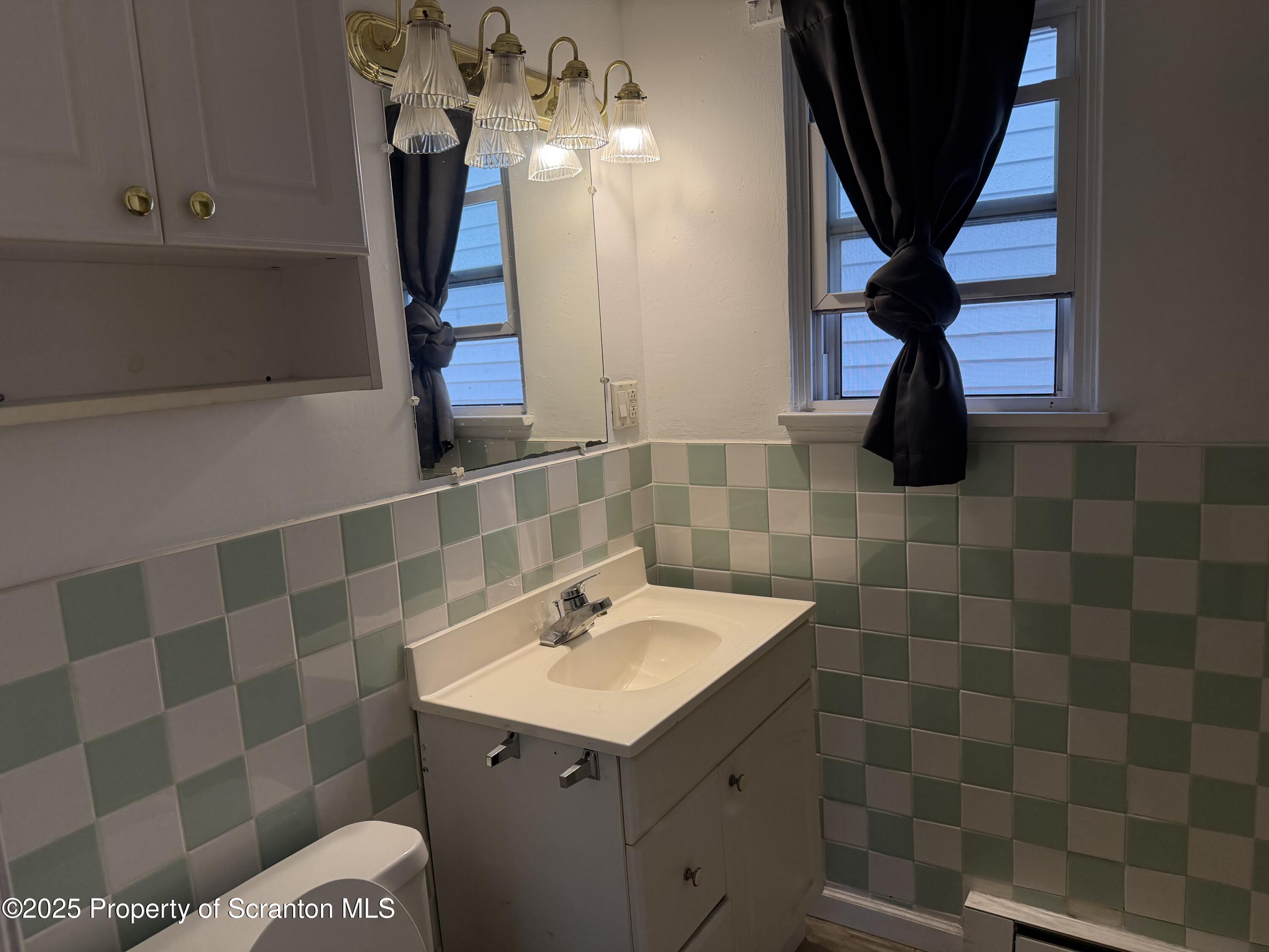 612 Oak Street Old Forge, PA 18518 - Photo 13 of 17 a bathroom with a sink and a mirror