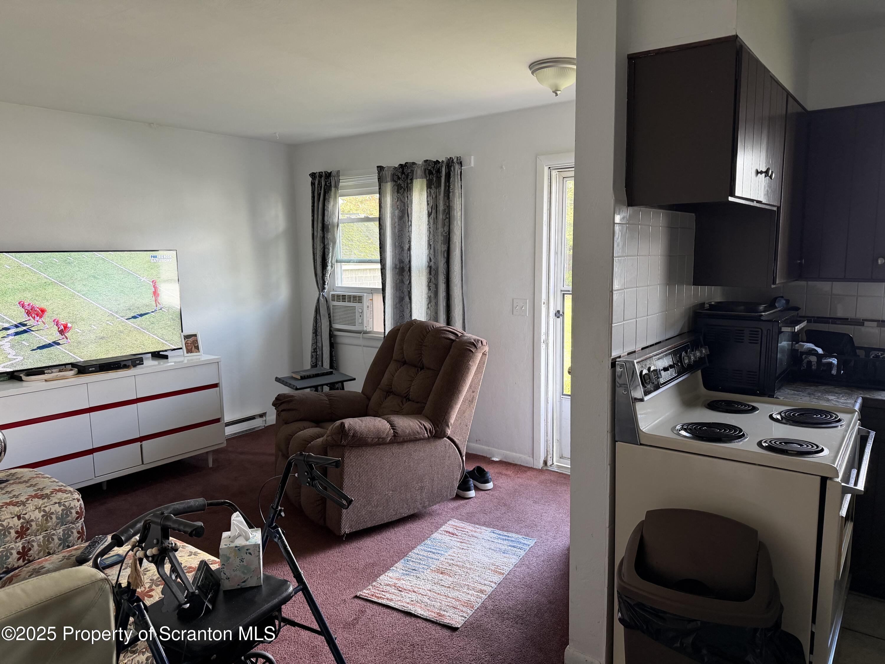 612 Oak Street Old Forge, PA 18518 - Photo 15 of 17 a living room with furniture and a flat screen tv