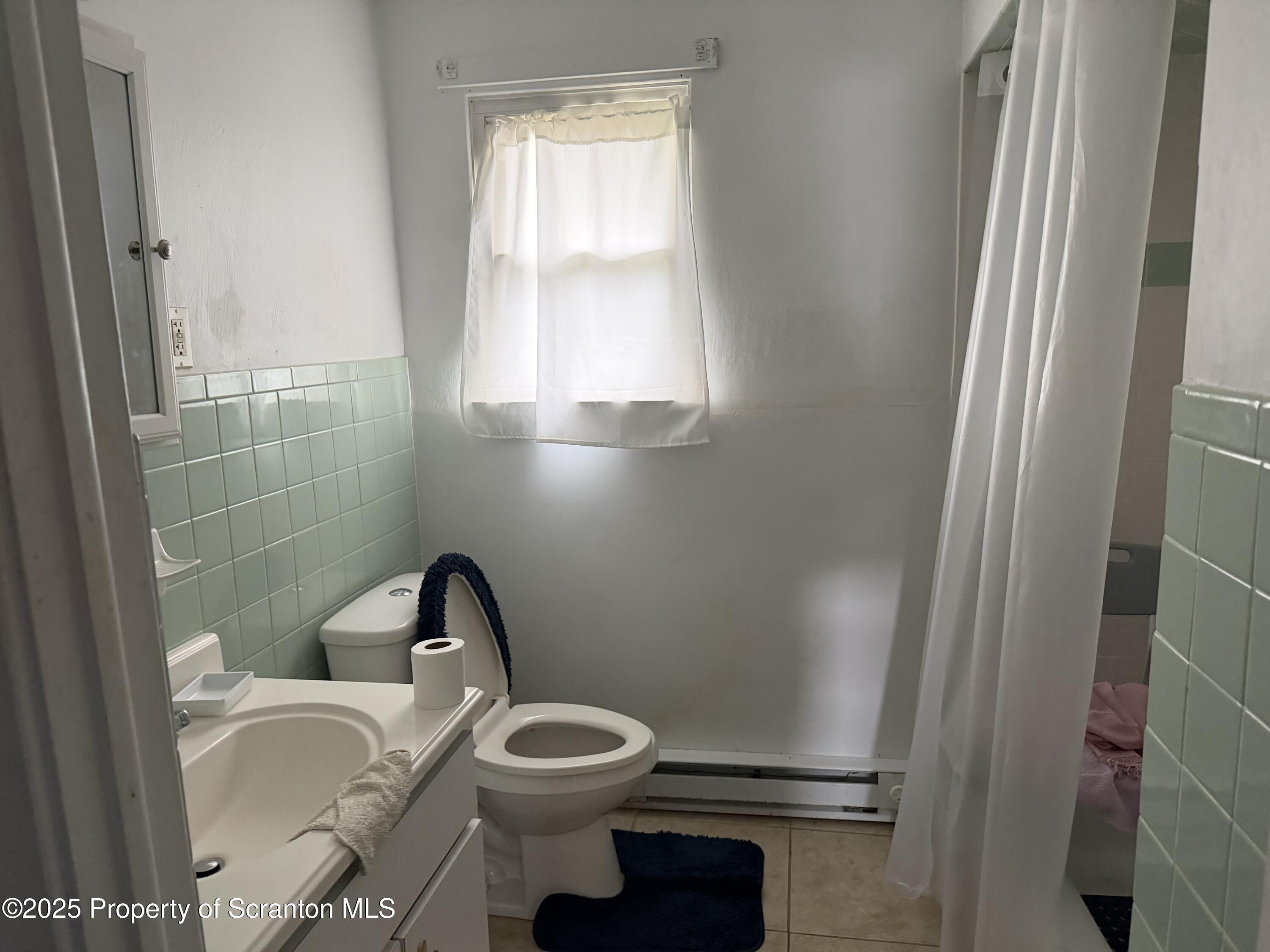 612 Oak Street Old Forge, PA 18518 - Photo 17 of 17 a bathroom with a toilet and a sink