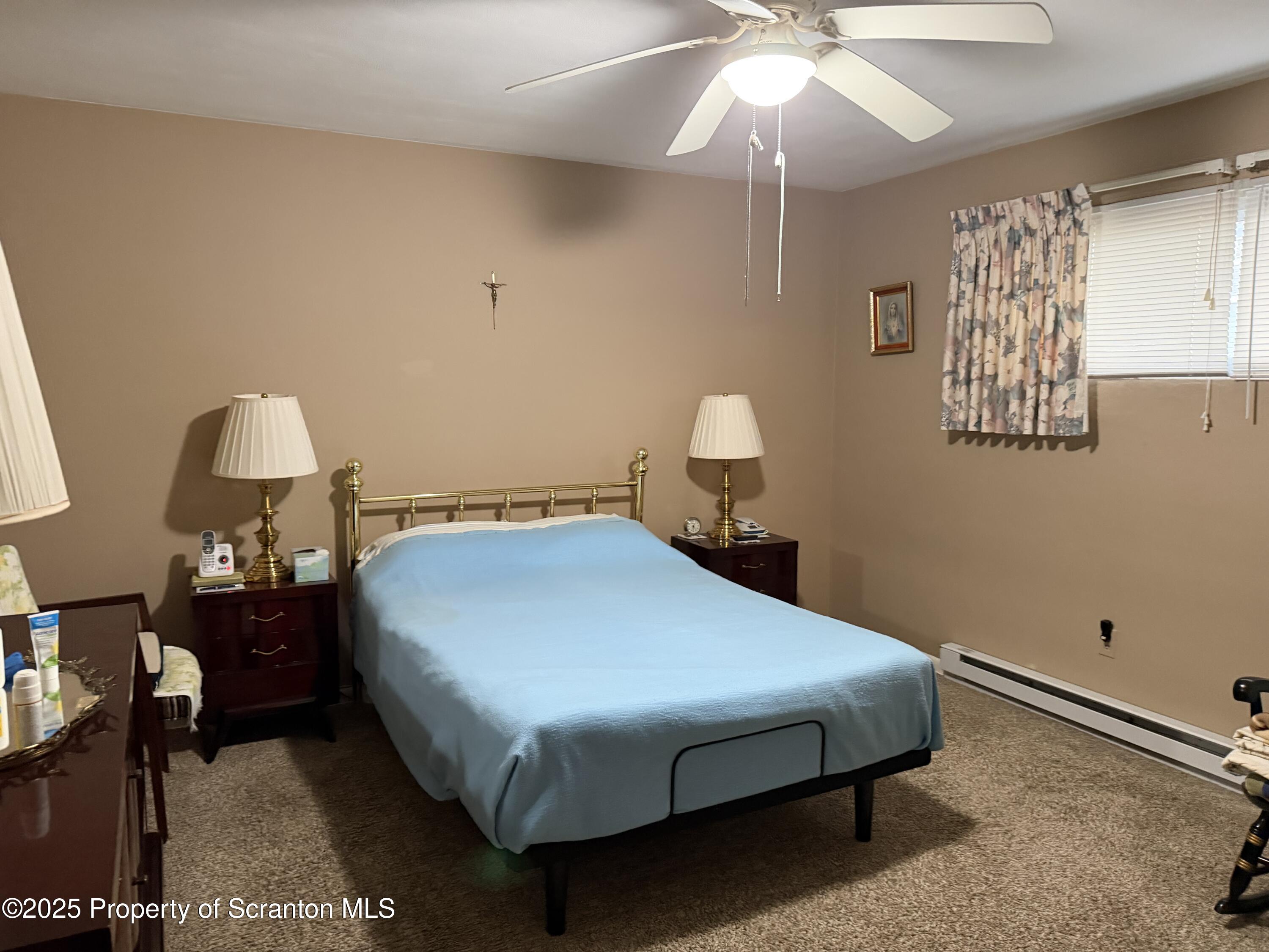 612 Oak Street Old Forge, PA 18518 - Photo 6 of 17 a bedroom with a bed and a chandelier