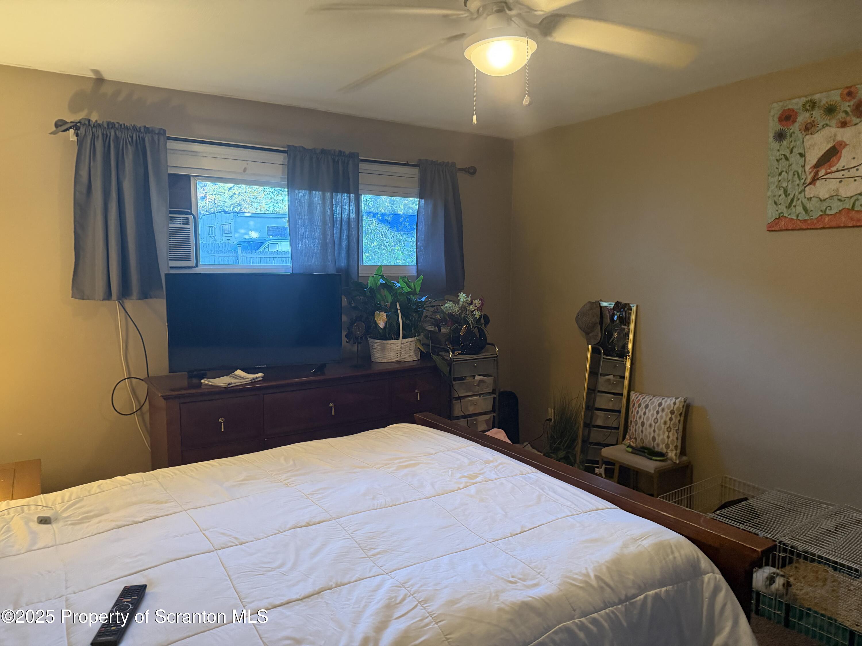 612 Oak Street Old Forge, PA 18518 - Photo 9 of 17 a bedroom with a bed and a flat screen tv
