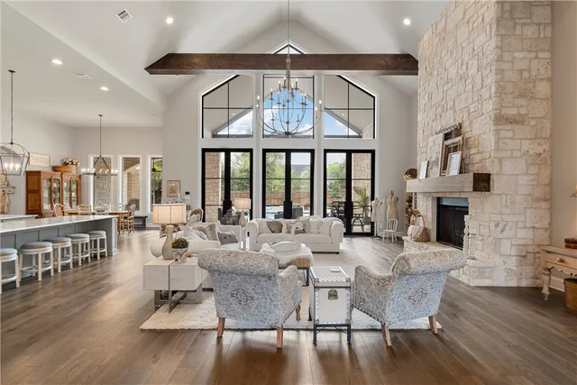 a kitchen with stainless steel appliances granite countertop a sink a stove and a wooden floors