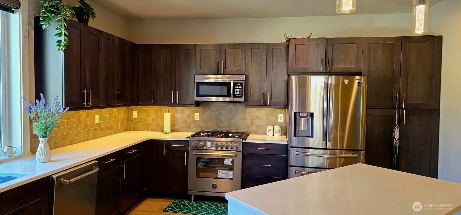 22823 23rd Avenue Southeast, Unit 8 Bothell, WA 98021 - Photo 15 of 17 a kitchen with a refrigerator and a sink