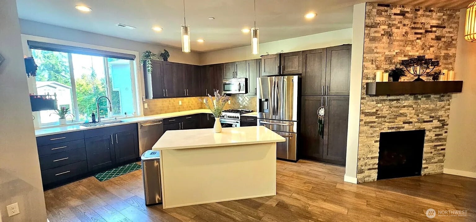 22823 23rd Avenue Southeast, Unit 8 Bothell, WA 98021 - Photo 16 of 17 a kitchen with sink cabinets and wooden floor