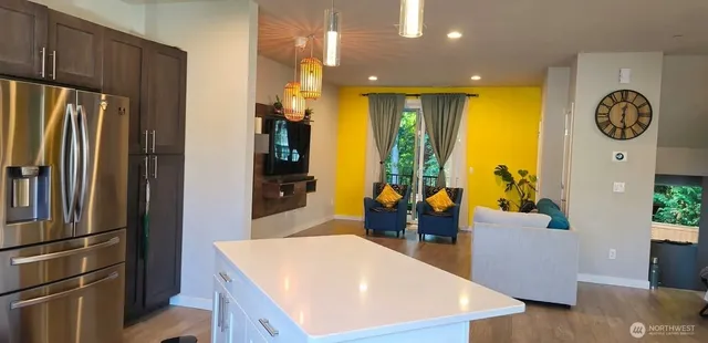 a kitchen with stainless steel appliances granite countertop a refrigerator a oven and a sink