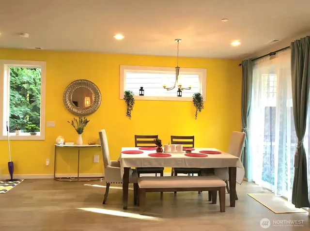 a view of a dining room with furniture and window