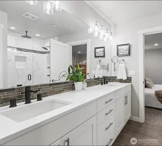 a spacious bathroom with a double vanity sink mirror and