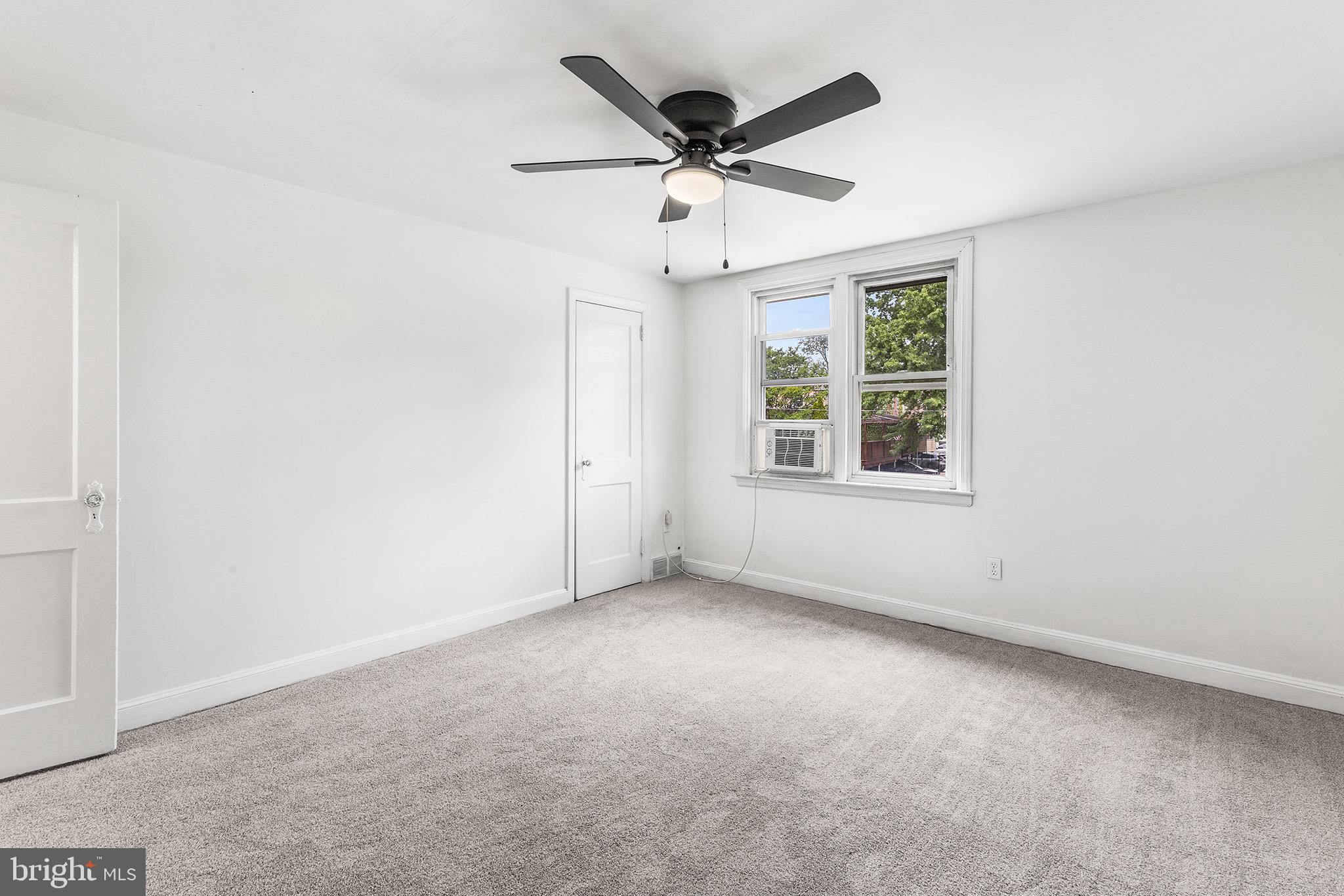 390 Glen Cove Road Collingdale, PA 19023 - Photo 13 of 27 an empty room with ceiling fan and windows