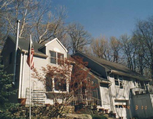 44 Mountain Road Redding, CT 06896 - Photo 1 of 1 a front view of a house with large trees