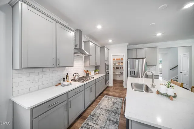 a kitchen with stainless steel appliances kitchen island granite countertop a sink and cabinets