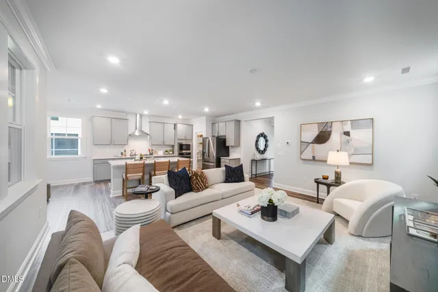 a living room with furniture kitchen view and a table