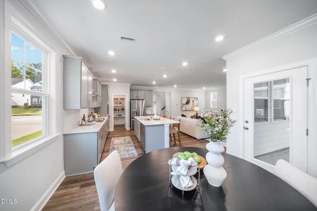a view of a dining room with furniture and wooden floor