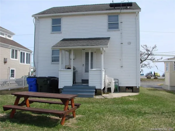 a front view of house with a garden