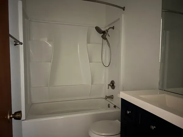 a bathroom with a sink a toilet and mirror
