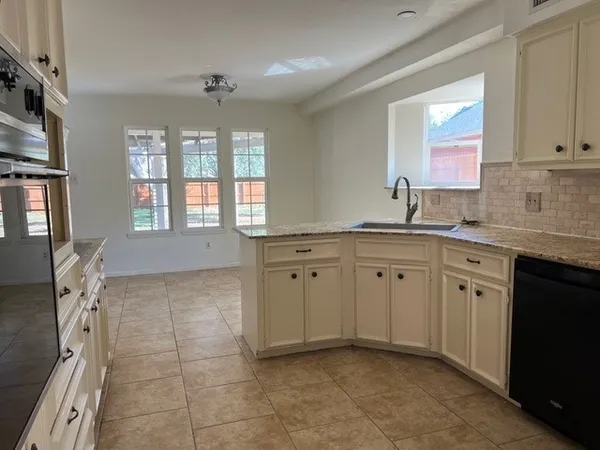 a kitchen with a sink stove and cabinets
