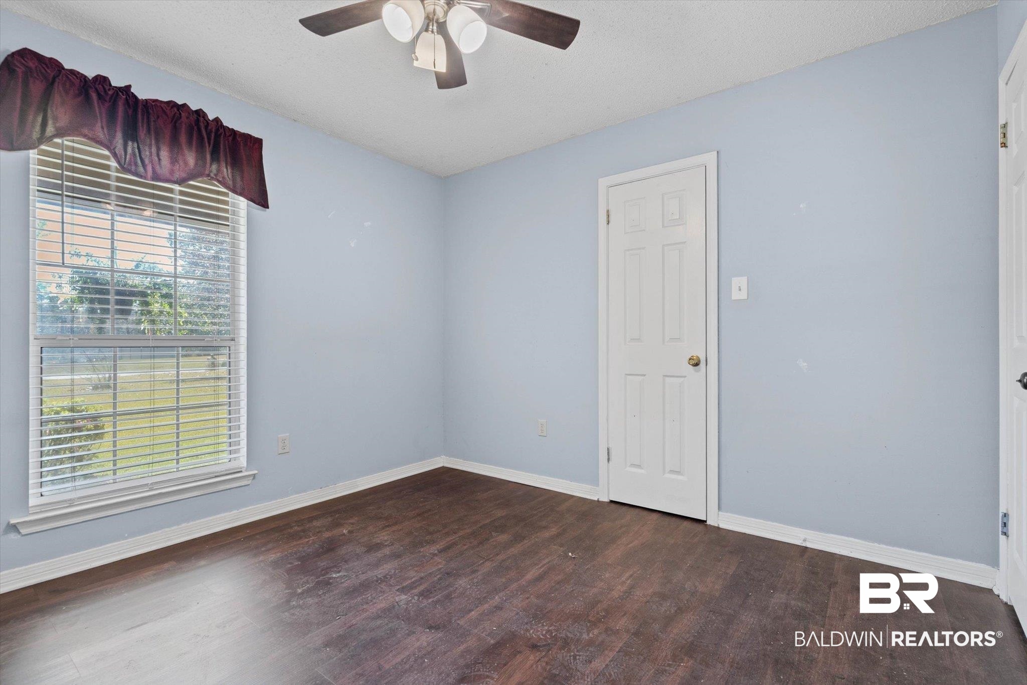 180 Creax Road Axis, AL 36505 - Photo 18 of 35 Empty room featuring dark wood finished floors, a textured ceiling, and ceiling fan