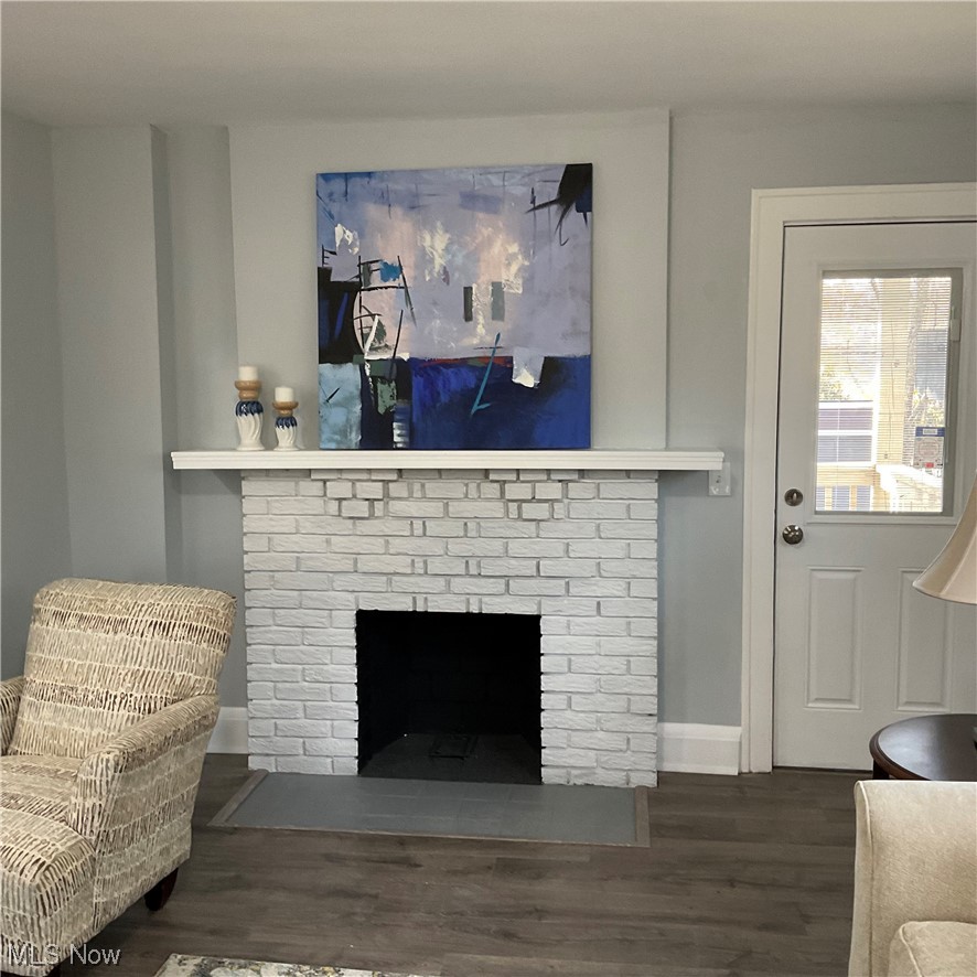 1058 Yellowstone Road Cleveland Heights, OH 44121 - Photo 7 of 28 Living room with dark hardwood / wood-style flooring and a brick fireplace