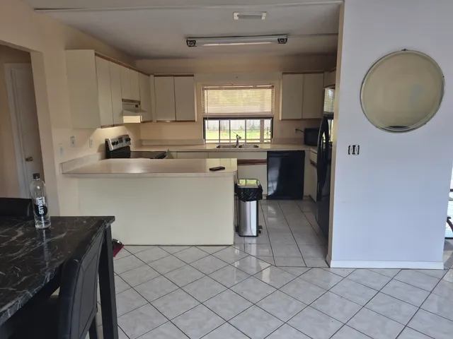 a kitchen with a sink cabinets and window