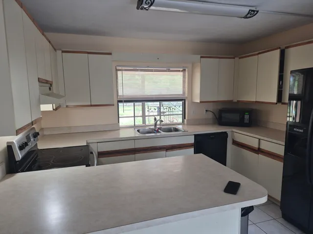 a kitchen with a sink and a large window