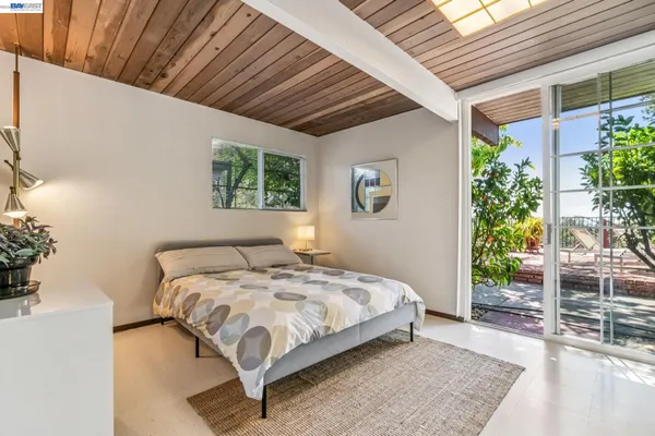 a bedroom with furniture and a window